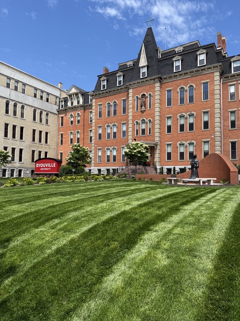 Striped lawn and maintained landscape beds at D’Youville University