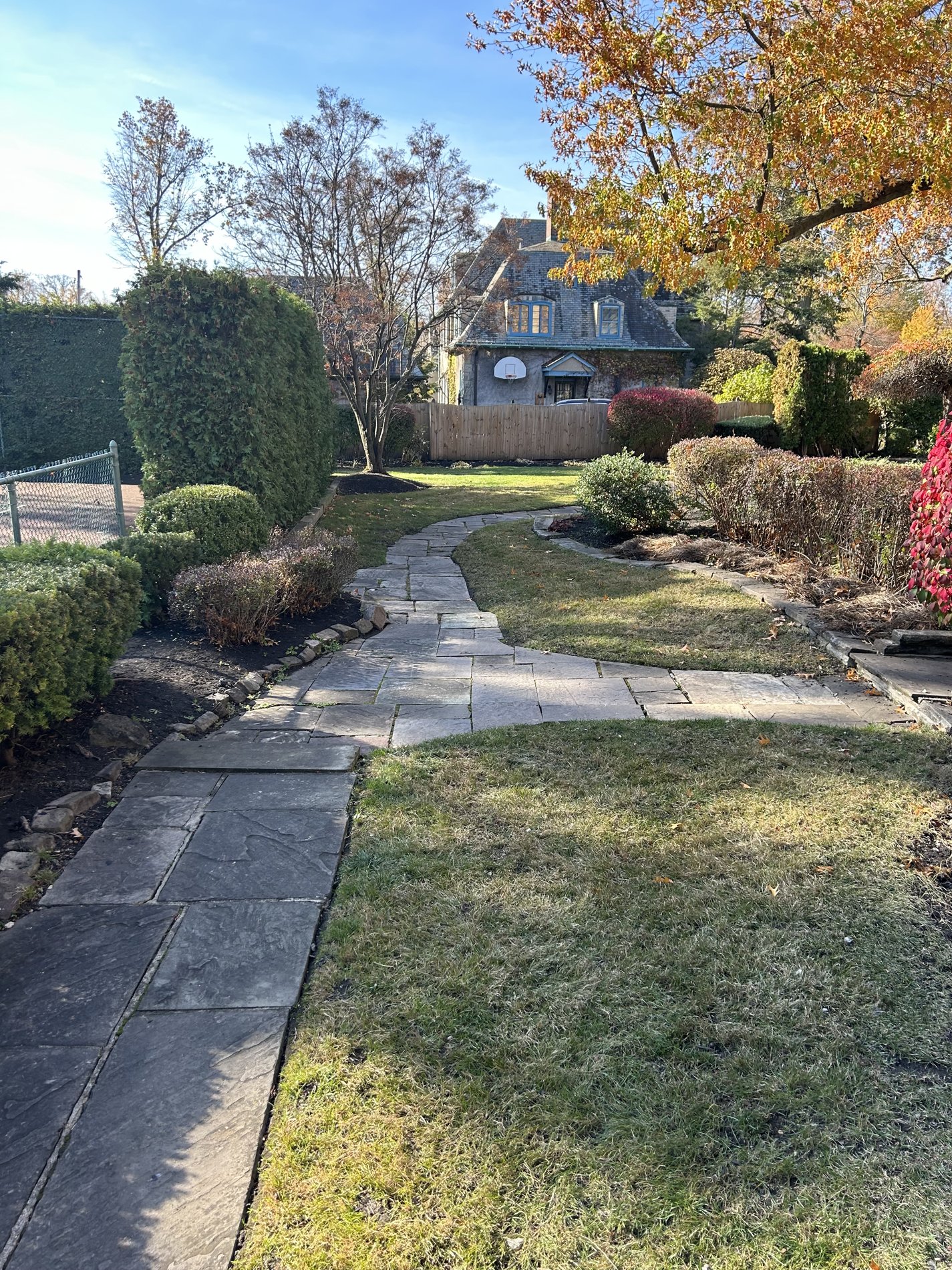 After: cleared lawn and stone walkway