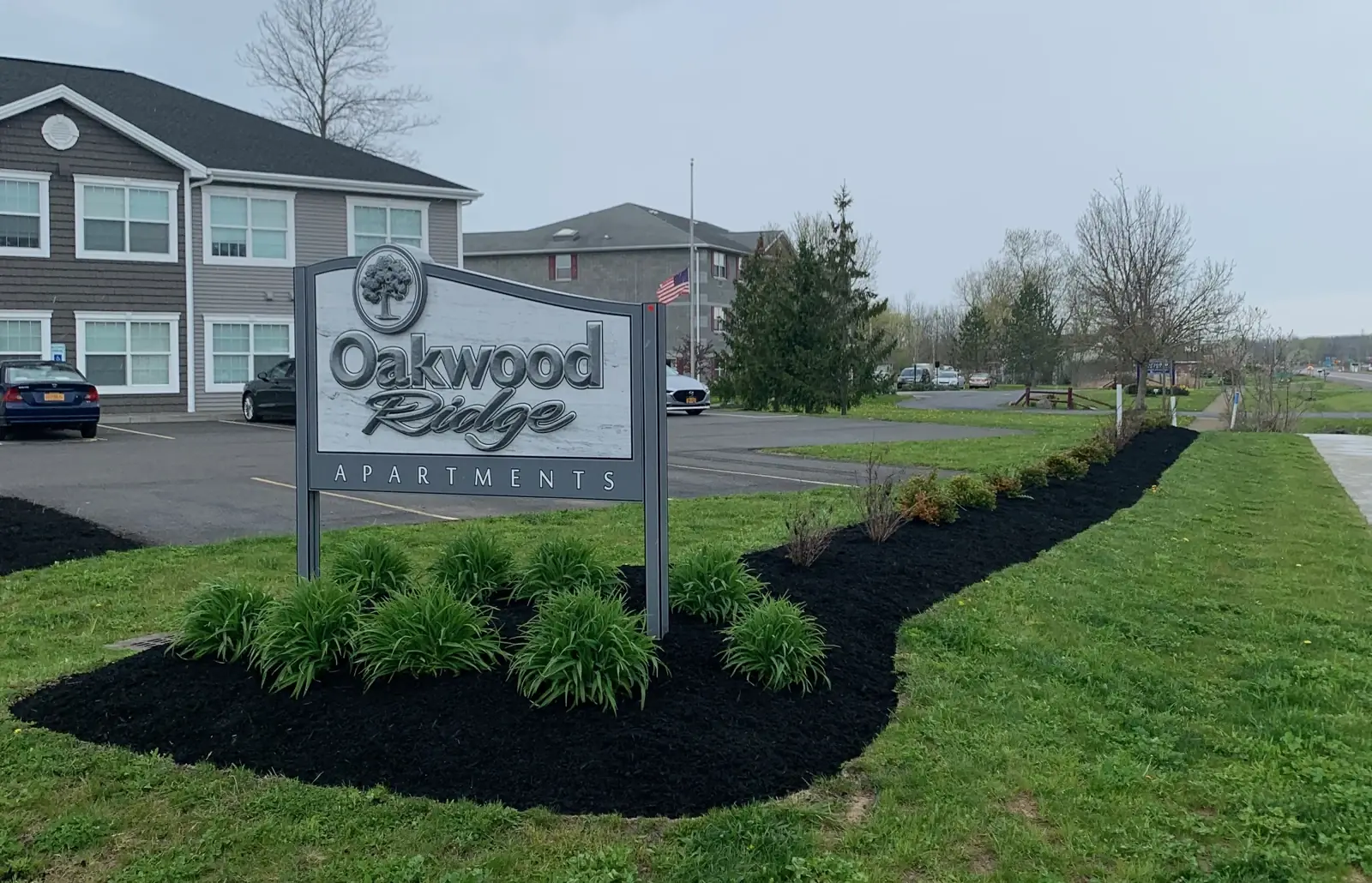 Oakwood Ridge Apartments entrance sign surrounded by freshly mulched black landscape beds